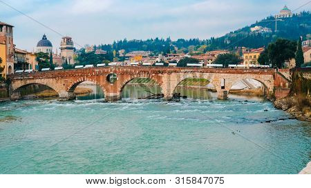 Roman Arch Bridge Over Adige River In Verona. Historical Center Of European City. Romantic Sightseen
