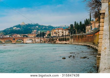 Roman Arch Bridge Over Adige River In Verona. Historical Center Of European City. Romantic Sightseen