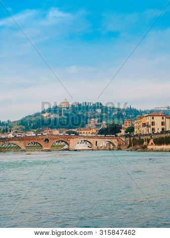 Roman Arch Bridge Over Adige River In Verona. Historical Center Of European City. Romantic Sightseen