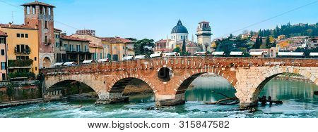 Roman Arch Bridge Over Adige River In Verona. Historical Center Of European City. Romantic Sightseen