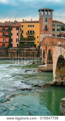 Roman Arch Bridge Over Adige River In Verona. Historical Center Of European City. Romantic Sightseen