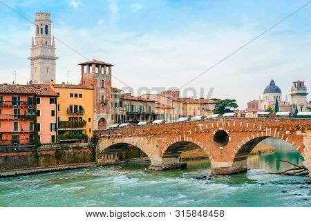 Roman Arch Bridge Over Adige River In Verona. Historical Center Of European City. Romantic Sightseen