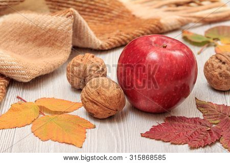 Apple, Walnuts And Dry Leaves In An Autumn Still Llife.