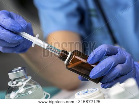 Nurse Preparing Medication For Parenteral Nutrition In A Hospital, Conceptual Image