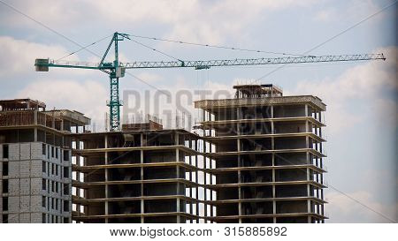 Construction Site Background. Hoisting Cranes And New Multi-storey Buildings. I.ndustrial Background