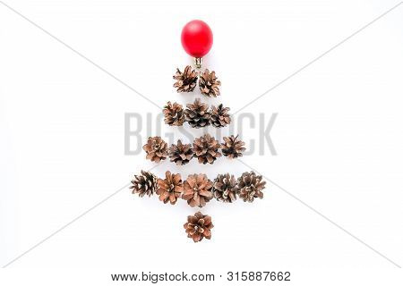 Christmas Composition With Christmas Fir Tree Made Of Pine Cones And Redball On White Background. Fl