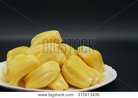 Fresh Jackfruit Slices On A White Plate. Sweet Yellow Jackfruit Ripe. Vegetarian, Vegan, Raw Food. E