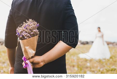 Beautiful Weding Bouquet In The Hands Of The Groom With Bride In A White Wedding Dress. Wedding Cere
