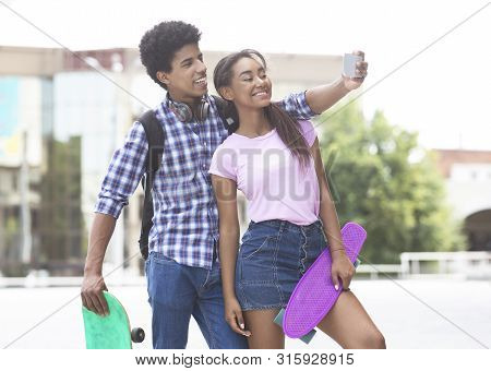 Selfie Time. Cheerful African Teenagers Capturing Self-portrait Outdoors. Free Space