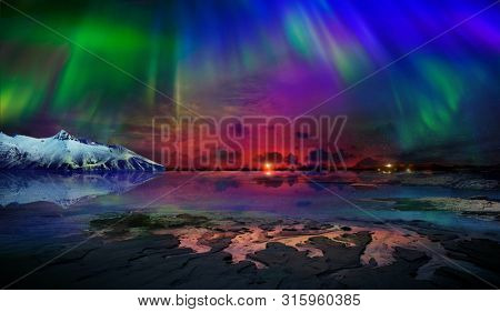 Beautiful northern lights of the northern part of the planet. Magnificent views of the ocean and northern lights with rocks and stones. Beautiful sea water plays with colors and light