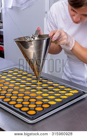 Pastry Chef In The Kitchen Makes Passion Fruit Confit. Cook Pours Passion Fruit Confit Into The Mold