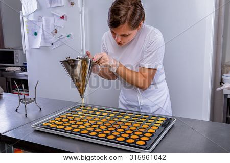 Pastry Chef In The Kitchen Makes Passion Fruit Confit. Cook Pours Passion Fruit Confit Into The Mold