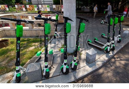 Bucharest, Romania - July 30, 2019: Several Lime-s Electric Scooters Are Parked On A Sidewalk In Buc