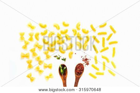 Wooden Spoons With Spices And Pasta On White Isolated Background. The Concept Of Italian Cuisine. Cl