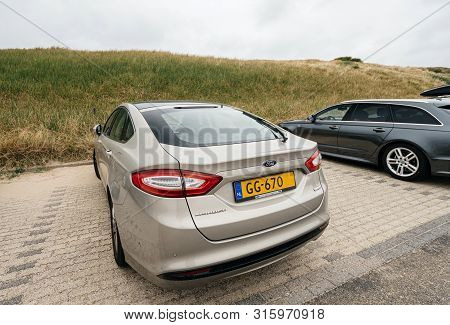 Overveen, Netherlands - Aug 16, 2018: Rear View Of New Ford Mondeo Parked On A Beach Park Space In N