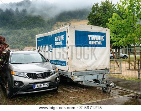 Ottenhofen Im Schwarzwald, Germany - Jul 28, 2019: Thule Rental Cargo Trail Tug In Parking Lot Next 