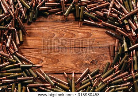 Different Ammo On Wooden Background, Weapon Concept.