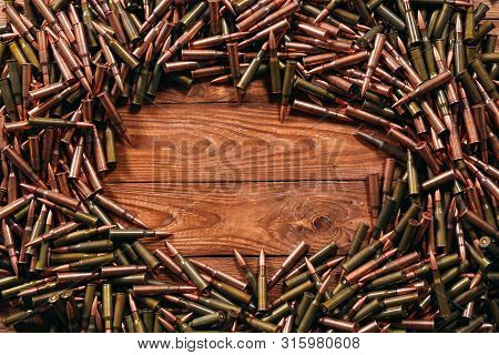Different Ammo On Wooden Background, Weapon Concept.