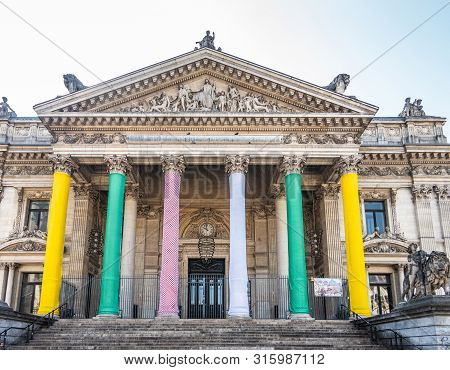 Brussels, Belgium -  June 22, 2019: Brown Stone Front Facade With Tall Columns And Tympanum With Sta