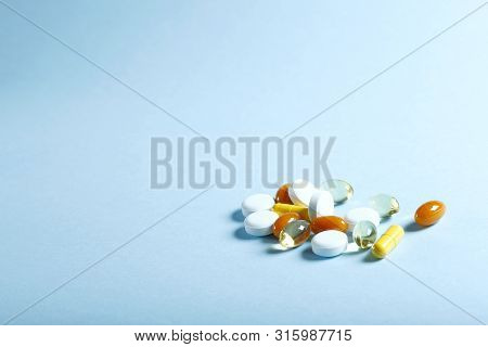 A Lot Of Bright Colored Medicine Pills On A Blue Background. Cropped Shot, Vertical, Side View, Clos