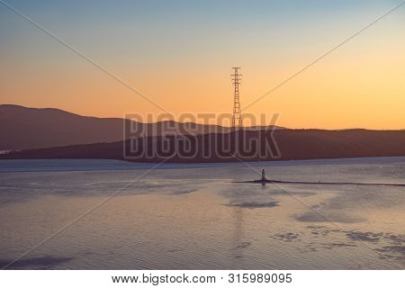 Seascape With A Beautiful Sunset Over The Tokarev Lighthouse. Vladivostok, Russia