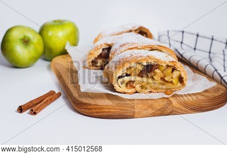 Classic Apple Strudel On A Wooden Board. Apfelstrudel