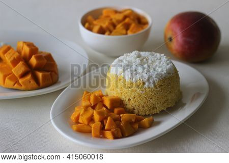 Steamed Ground Rice, Layered With Coconut Shavings And Mango. Locally Known As Mango Puttu. A Tradit