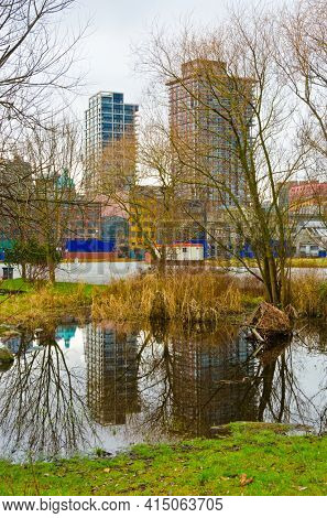 A view at Downtown and it's reflection in water of padle in Vancouver, Canada from Portside Park.