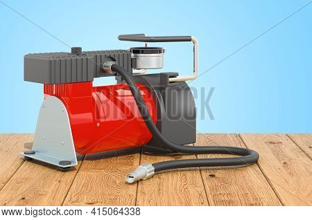Car Portable Electric Air Compressor On The Wooden Table. 3d Rendering