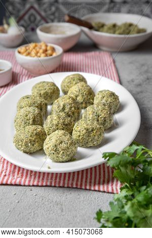 Traditional Homemade Chickpea Raw Falafel Balls With White Sauce And Pita Bread On Whitw Plate On Wo