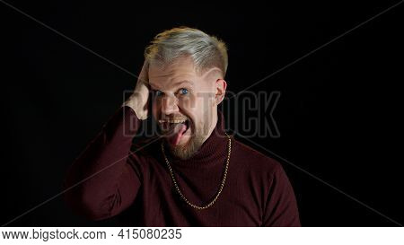 Comical Stupid Stylish Man With Blue Eyes In Trendy Clothes Making Funny Awkward Silly Face Grimace,