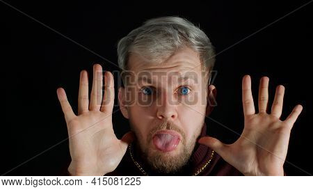 Comical Stupid Stylish Man With Blue Eyes, Hiding Behind Hands, Making Funny Awkward Silly Face Grim