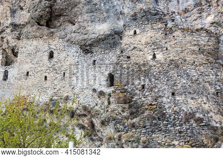 Ancient Dwellings In The Mountains. Kurtat Gorge In North Ossetia-alania, Russia. Stone Cave Houses 
