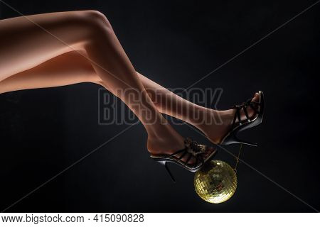 Celebrate Concept. Heels With Gold Ball. Disco And Party Legs. Party Time