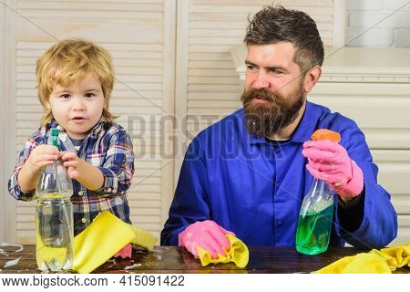 Dad And Kid Having Fun During Cleaning. Man With Child Plays With Soapsuds. Father Is Teaching A Son