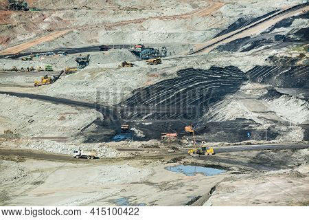 Mining Dump Trucks Working In Coalmine , Used As A Source Of Electricity Generation In The Country.
