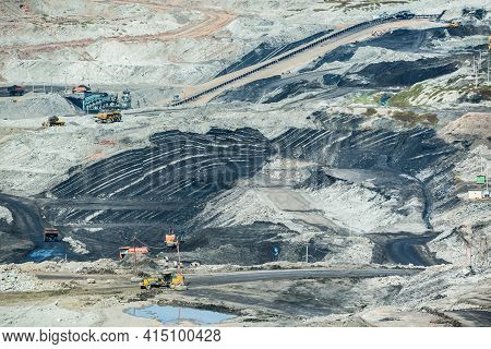 Mining Dump Trucks Working In Coalmine , Used As A Source Of Electricity Generation In The Country.