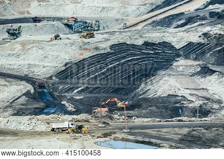 Mining Dump Trucks Working In Coalmine , Used As A Source Of Electricity Generation In The Country.