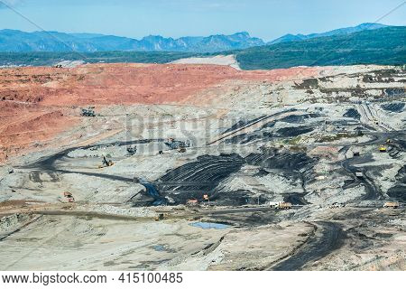 Mining Dump Trucks Working In Coalmine , Used As A Source Of Electricity Generation In The Country.
