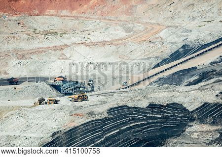 Mining Dump Trucks Working In Coalmine , Used As A Source Of Electricity Generation In The Country.