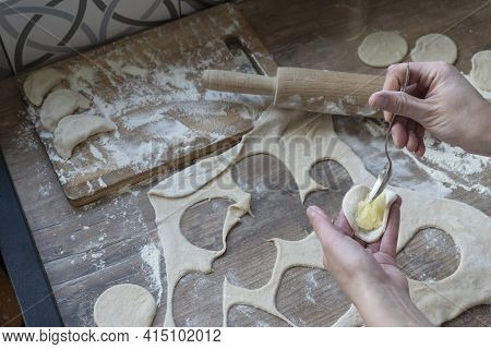 Process Of Stuffing Vareniki, Russian Traditional Dish, Woman Hands With Tea Spoon, Rolled Dough, Ro