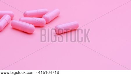 Pink Capsule Pills On Pink Background. Vitamin And Supplement For Healthy Skin Use In Beauty Clinic 