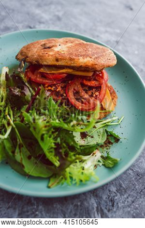 Vegan Burger With Turkish Bread Bun Tomatoes Dairy-free Cheese And Plant-based Patty Served With Sid
