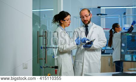 Chemist Nurse Explainig To Doctor Vaccine Development
