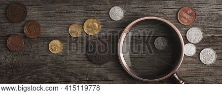 Numismatics. Old Collectible Coins Made Of Silver On A Wooden Table. A Collector In Special Gloves H