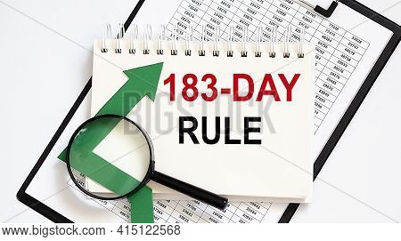 Notebook With Tools And Notes About 183 Day Rule With Chart ,magnifier