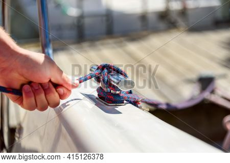 Man Hand With Boat Rope, Yachtsman Tying Sea Knot. Human Hand On Sailing Boat Or Yacht Tying A Knot,