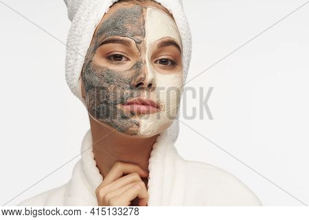 Mask Against Black Dots On The Face Of A Woman With A Towel On Her Head