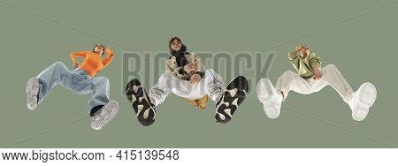 Young Stylish People In Modern Street Style Outfit Isolated On Green Background, View From The Botto