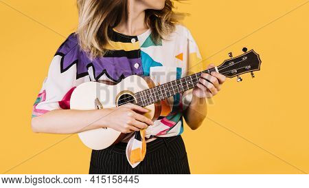 Girl Playing Ukelele. High Quality And Resolution Beautiful Photo Concept